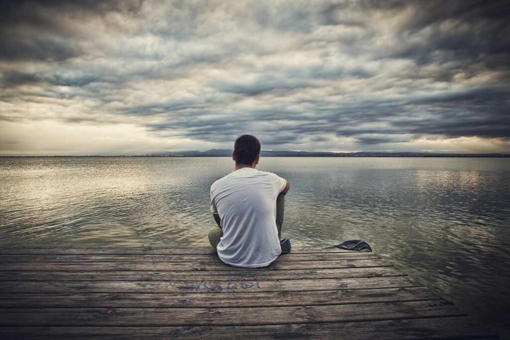 Man sitting alone on beach