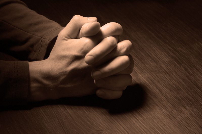 Praying with hands folded